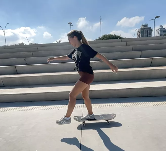 aluna andando de skate na Orla embalando com estilo