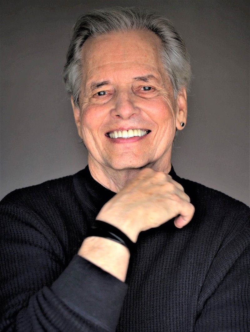 MARK W. TRAVIS