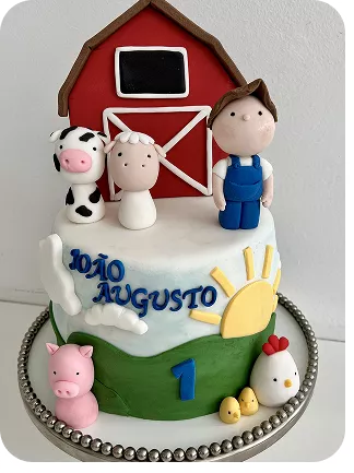 Bolo no tema Fazendinha, com fazendeiro, vaquinha e ovelha babies na frente do celeiro no topo do bolo, na base uma galinha e seus 2 pintinhos e um porquinho todos com feições de baby do Curso Meu Primeiro Zoológico - Modele 25 Animais em Pasta Americana